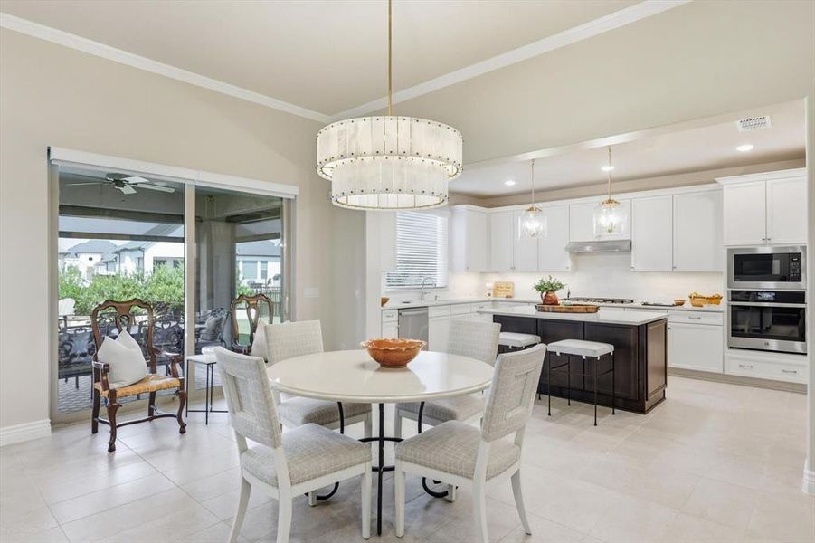 Dining room featuring crown molding, recessed lighting, ceiling fan, and light tile patterned floors