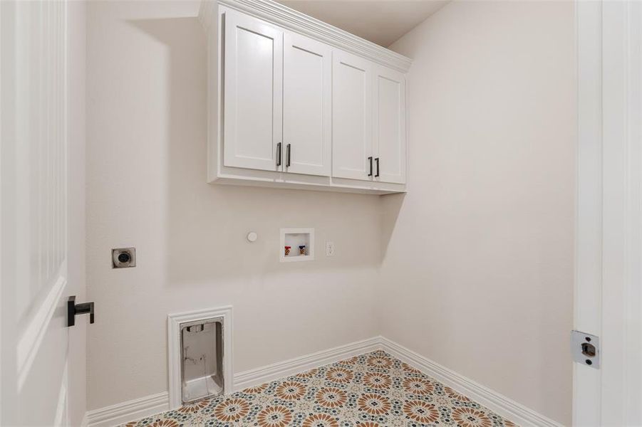 Clothes washing area featuring washer hookup, hookup for a gas dryer, cabinets, and electric dryer hookup