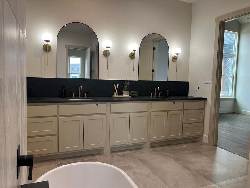 Bathroom with vanity and a tub