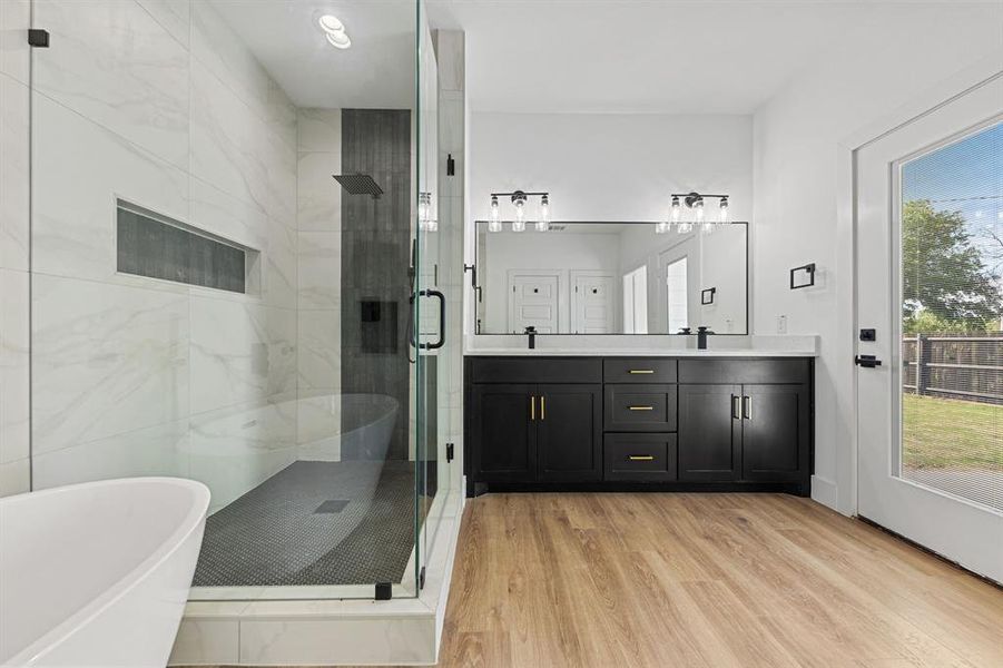 This contemporary bathroom features a spacious glass-enclosed shower with mosaic tile flooring and a built-in niche This contemporary bathroom features a spacious glass-enclosed shower with mosaic tile flooring and a built-in niche