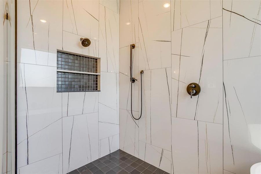 Bathroom featuring a tile shower