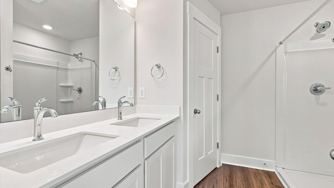Notable primary suite with dual vanities and walk-in shower in this prime Piedmont villa Notable primary suite with dual vanities and walk-in shower in this prime Piedmont villa