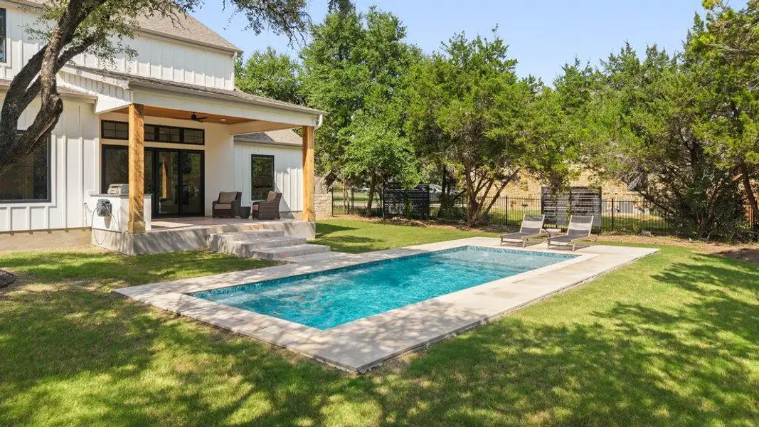 A refreshing pool awaits, perfectly complementing the home's covered patio and verdant backyard. A refreshing pool awaits, perfectly complementing the home's covered patio and verdant backyard.