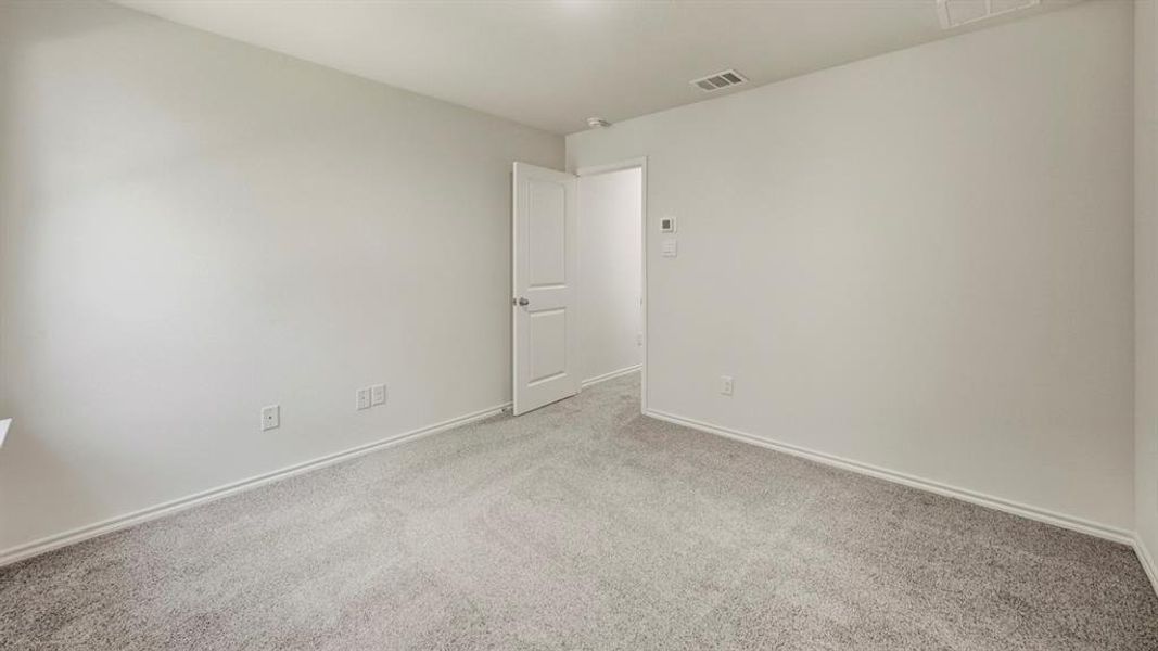 Unfurnished room with carpet flooring and baseboards