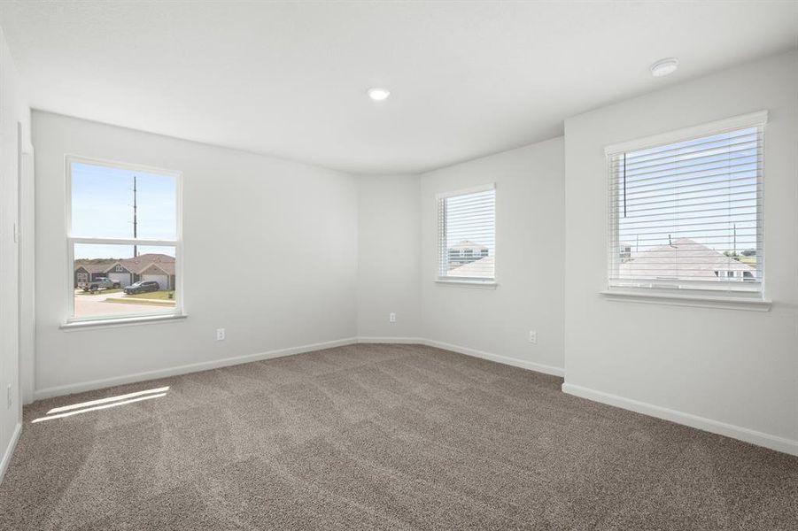 Carpeted empty room featuring healthy amount of natural light and recessed lighting