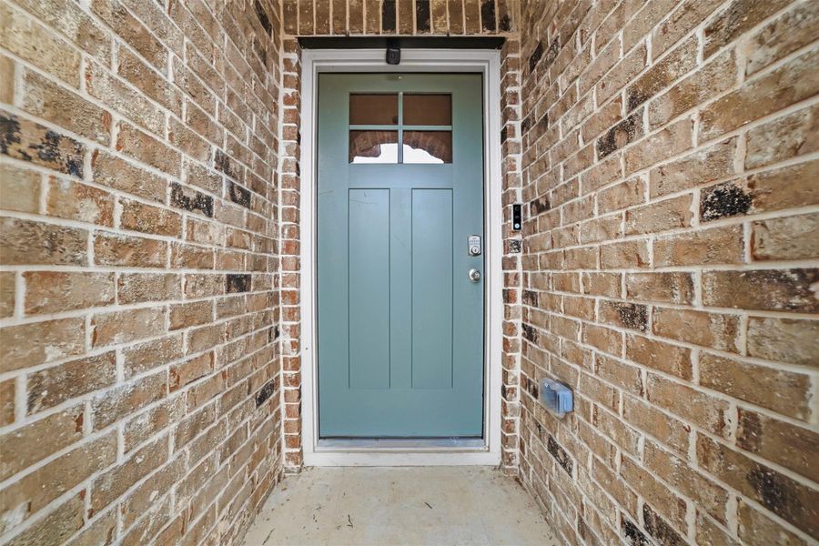 Property entrance with brick siding Property entrance with brick siding