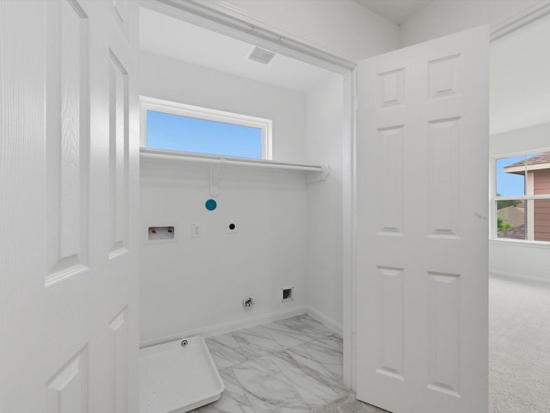 Thoughtfully positioned for everyday convenience, the utility room offers a dedicated space for laundry and household organization.