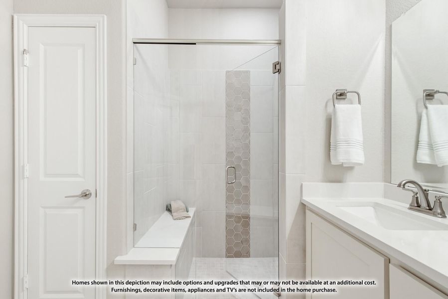 Bathroom with glass walk-in shower, built-in bench, white tile, and vanity with undermount sink