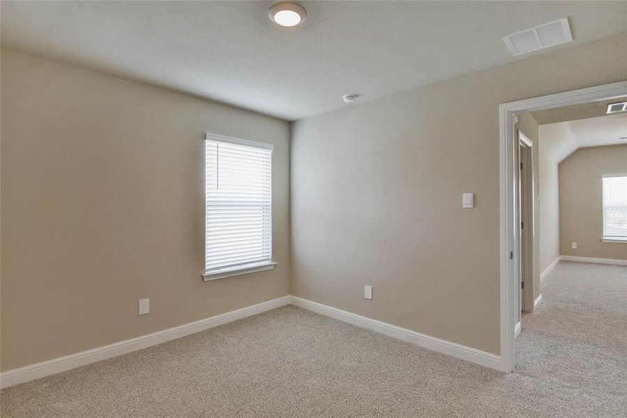 Spare room featuring light colored carpet and baseboards Spare room featuring light colored carpet and baseboards