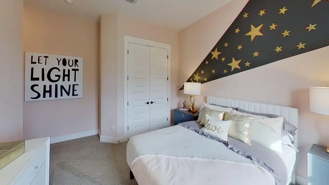 Bedroom featuring light carpet and a closet