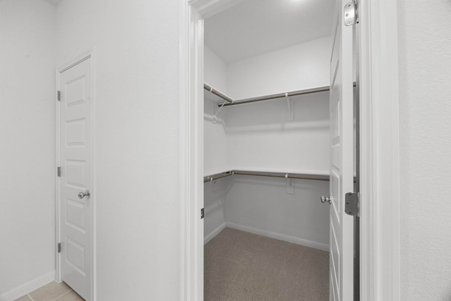 Primary Closet in the Cypress home plan by Trophy Signature Homes - REPRESENTATIVE PHOTO