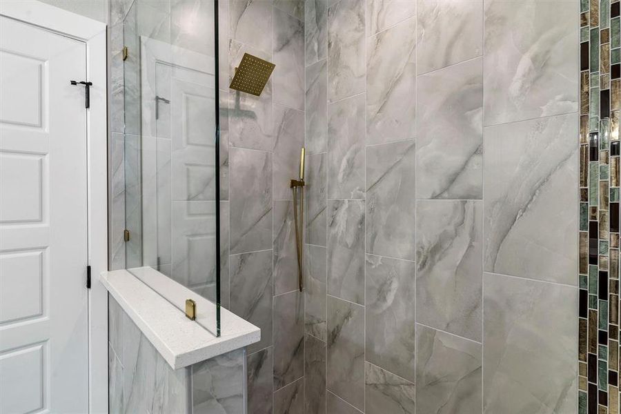 Bathroom featuring tiled shower