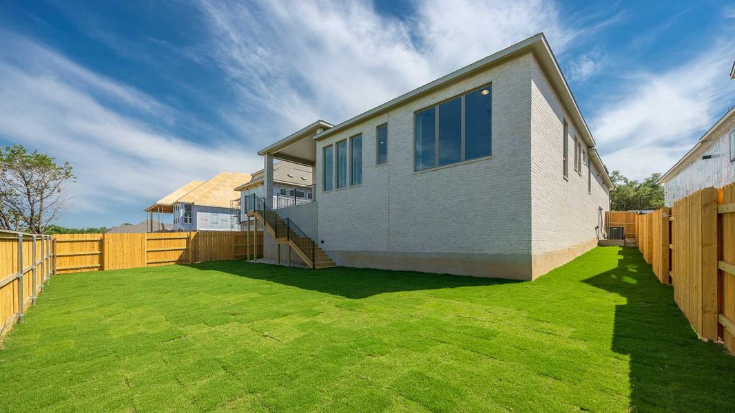 Back of house with brick siding, stairway, and central air condition unit Back of house with brick siding, stairway, and central air condition unit