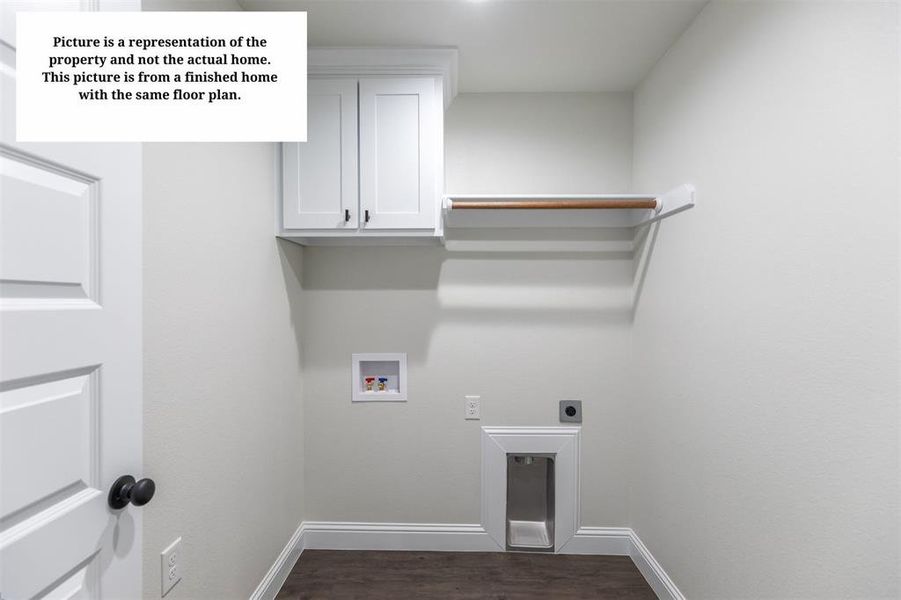 Dedicated laundry space featuring white cabinetry with black hardware, wood-finish flooring, a built-in hanging rod, and essential appliance hookups