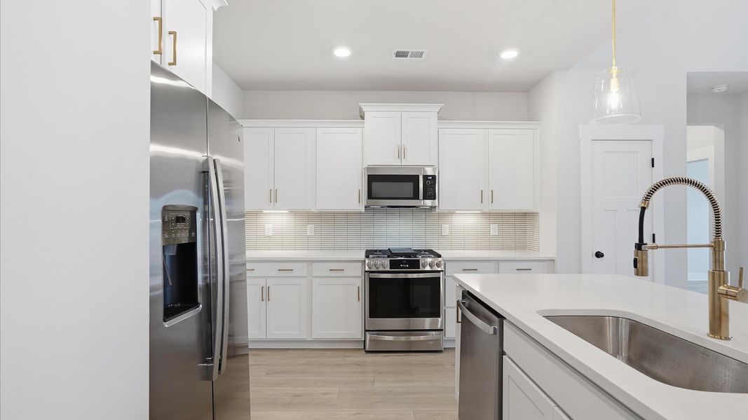 Tasteful kitchen with oversized island and stylish pendant lighting—crafted to high standards located near Downtown Anderson Tasteful kitchen with oversized island and stylish pendant lighting—crafted to high standards located near Downtown Anderson