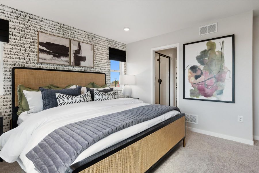 A bedroom with a bed and a painting on the wall. A bedroom with a bed and a painting on the wall.