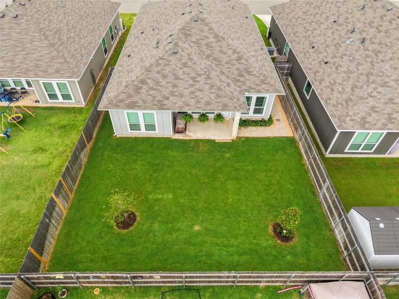 A well-maintained fenced backyard offers ample green space and a private patio. A well-maintained fenced backyard offers ample green space and a private patio.