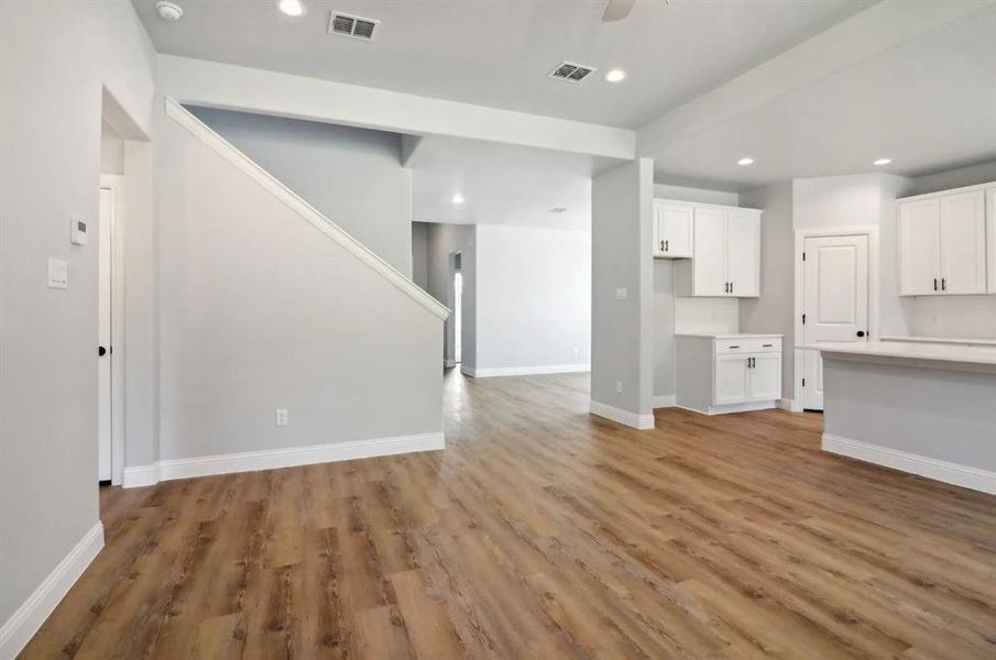 Unfurnished living room with hardwood / wood-style flooring and ceiling fan