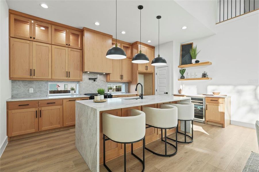 Kitchen with a kitchen bar, light stone counters, pendant lighting, light wood-style floors, and open shelves