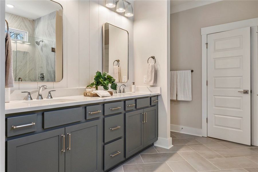 This bathroom features dual sinks and contemporary