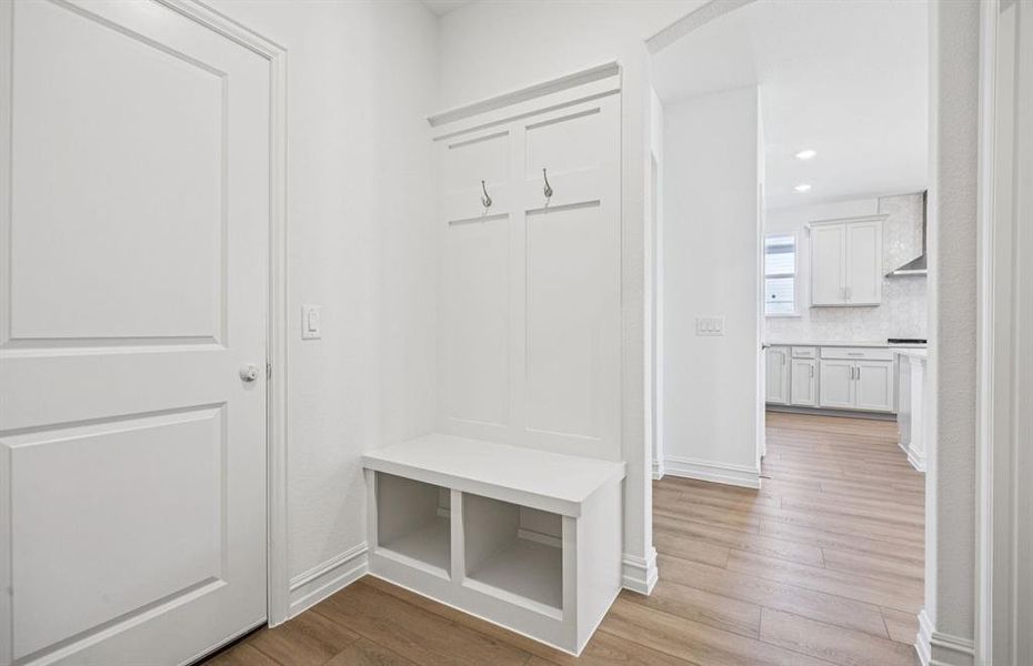 Mud room with built-in bench and hooks for added storage Mud room with built-in bench and hooks for added storage