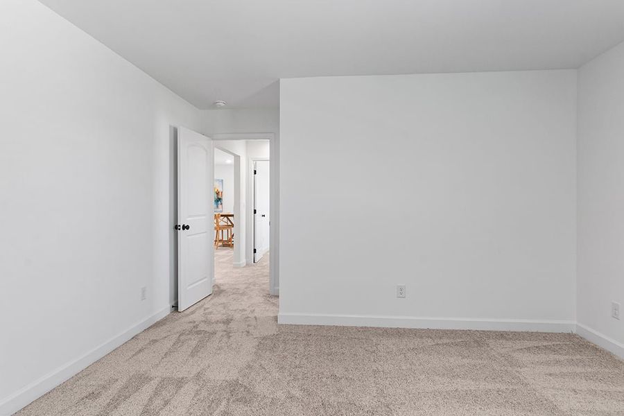A hallway with white walls.