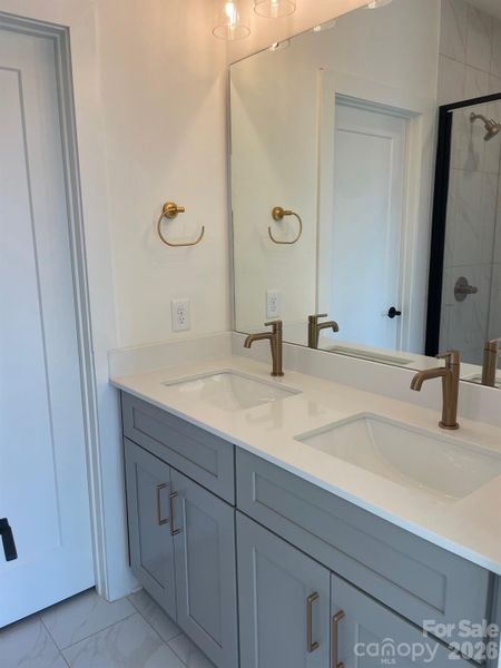 Upgraded gold fixtures - Primary Bathroom. Tile to the ceiling Upgraded gold fixtures - Primary Bathroom. Tile to the ceiling