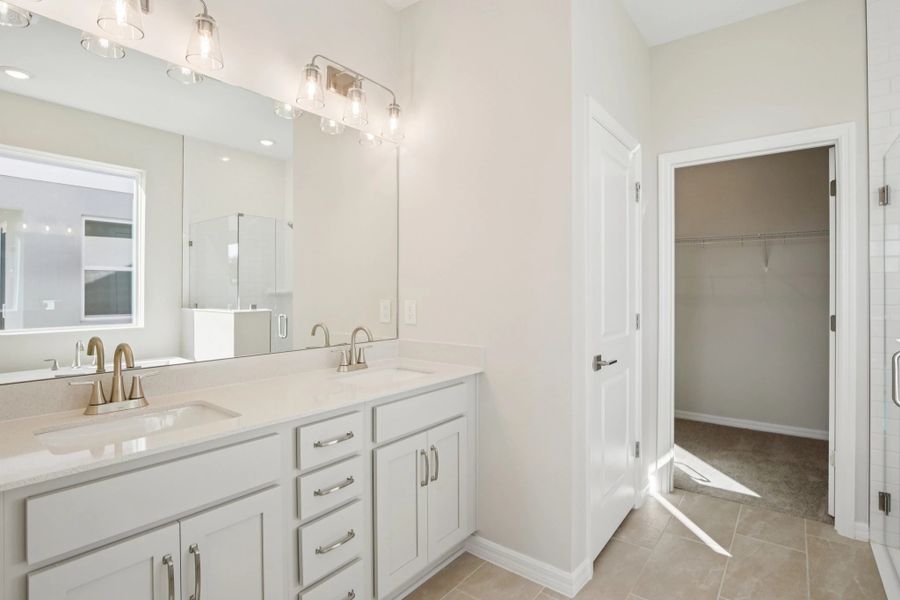 Beautiful primary bathroom featuring double sinks and aspects of AW Collection® Milan