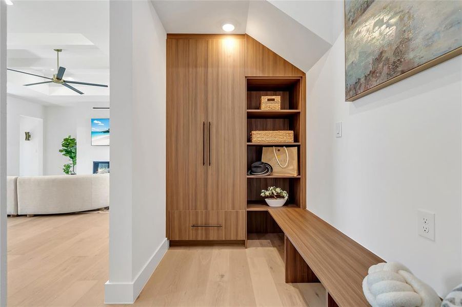 Mudroom with light wood-type flooring, ceiling fan, and built in features Mudroom with light wood-type flooring, ceiling fan, and built in features