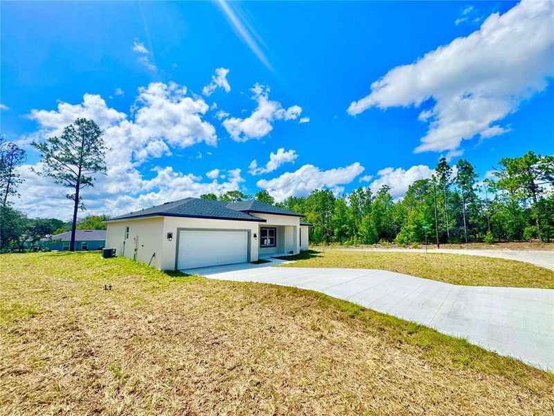 Front exterior of a new home in , Dunnellon, FL, highlighting curb appeal (Image 1).