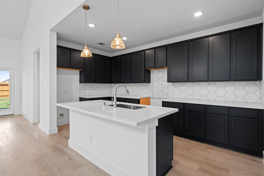 This beautiful brand new kitchen boasts stunning cabinetry that stretches to the ceiling, offering both style and ample storage for all your culinary treasures.