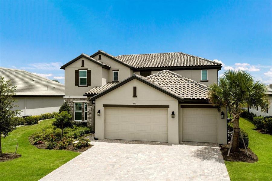 Front exterior of a new home in Sweetwater at Lakewood Ranch, Bradenton, FL, highlighting curb appeal (Image 26).