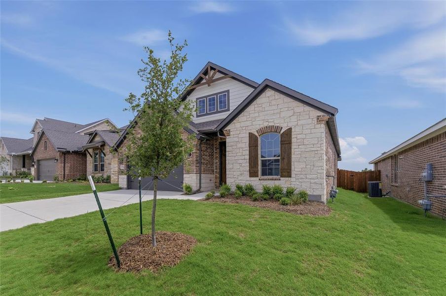 Exterior featuring a mixed material facade with light-colored stone and brick accents Exterior featuring a mixed material facade with light-colored stone and brick accents