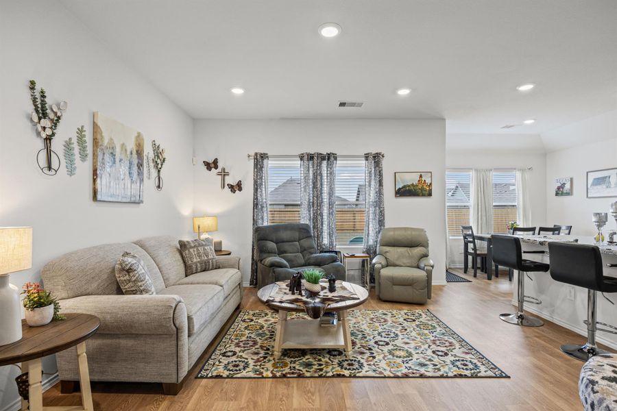 Living room featuring light wood-style flooring and recessed lighting