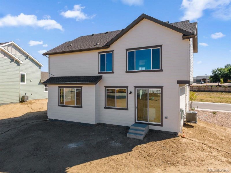 Front exterior of a new home in Cherry Meadows, Brighton, CO, highlighting curb appeal (Image 20).