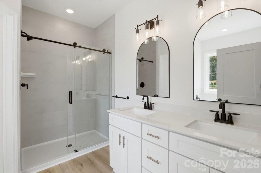 ensuite primary full bath- dual vanity, tiled shower, & tiled tub ensuite primary full bath- dual vanity, tiled shower, & tiled tub