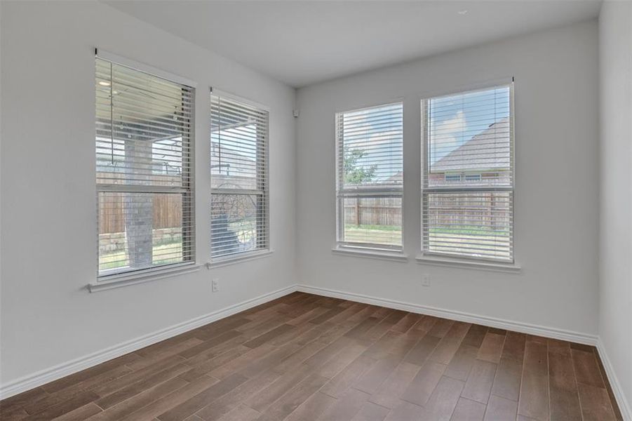 Dining area featuring beautiful hardwood and views to the backyard