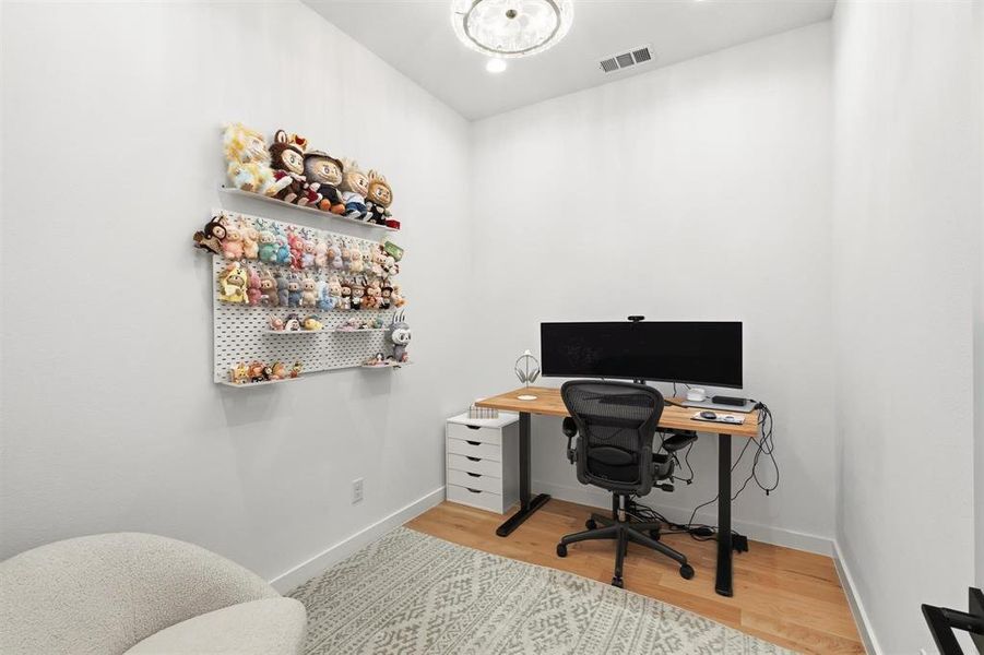 Office space featuring light wood finished floors and baseboards