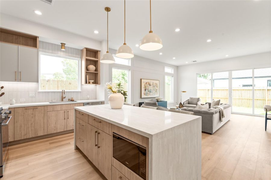 he kitchen opens directly into the living space, so cooking, hosting, and relaxing all happen in one continuous rhythm. It's the kind of layout that makes a house feel bigger than its footprint.