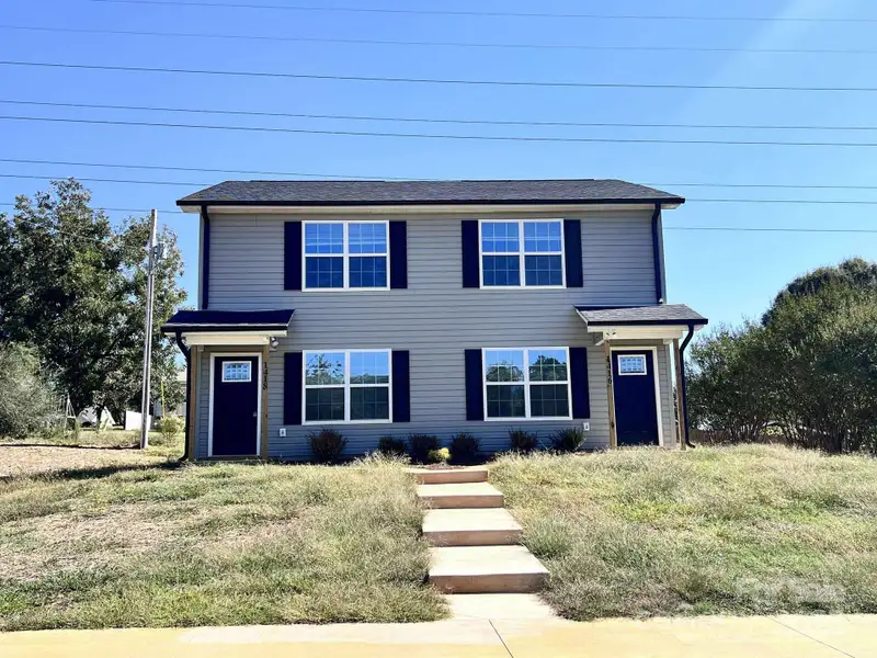 Front exterior of a new home in , Albemarle, NC, highlighting curb appeal (Image 1).