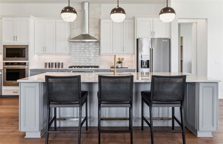 Bright kitchen with an expansive center island perfect for gatherings  *Real home pictured