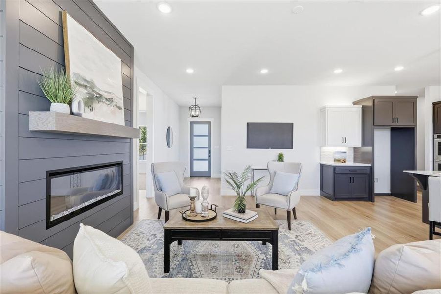 Living room with electric fireplace and recessed lighting