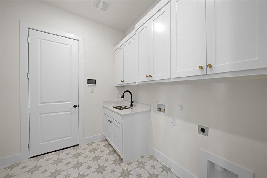 Laundry room with electric dryer hookup, hookup for a washing machine, cabinet space, and hookup for a gas dryer Laundry room with electric dryer hookup, hookup for a washing machine, cabinet space, and hookup for a gas dryer