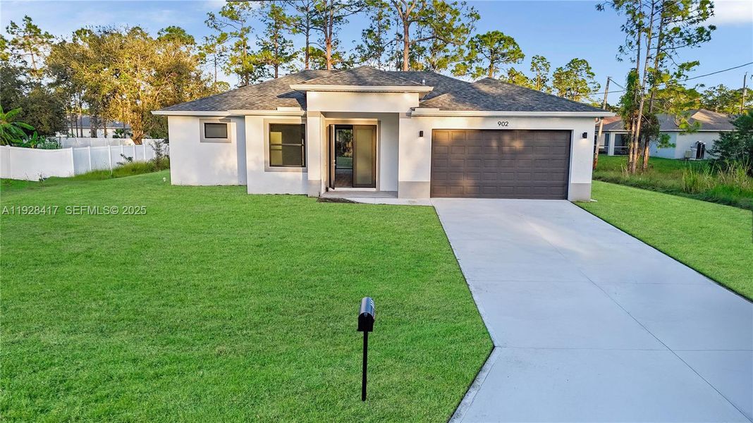 Front exterior of a new home in , Lehigh Acres, FL, highlighting curb appeal (Image 18). Front exterior of a new home in , Lehigh Acres, FL, highlighting curb appeal (Image 18).