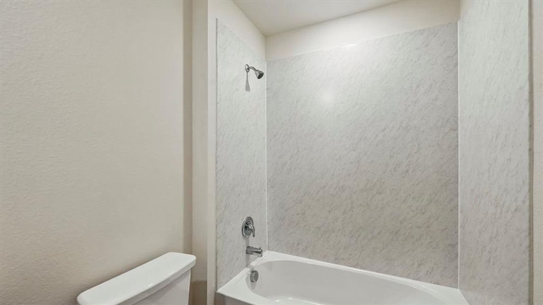 Full bath featuring bathing tub / shower combination and toilet