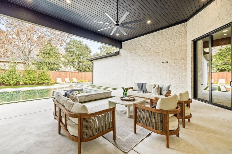 The covered back patio creates an easy extension of the home, offering a shaded space for outdoor dining, lounging, or hosting throughout the year