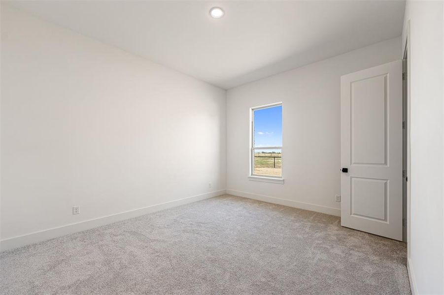 Spare room with light carpet and recessed lighting