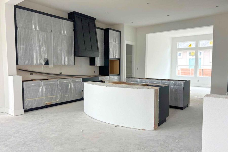 Kitchen with premium range hood, a center island, dark cabinets, and concrete flooring