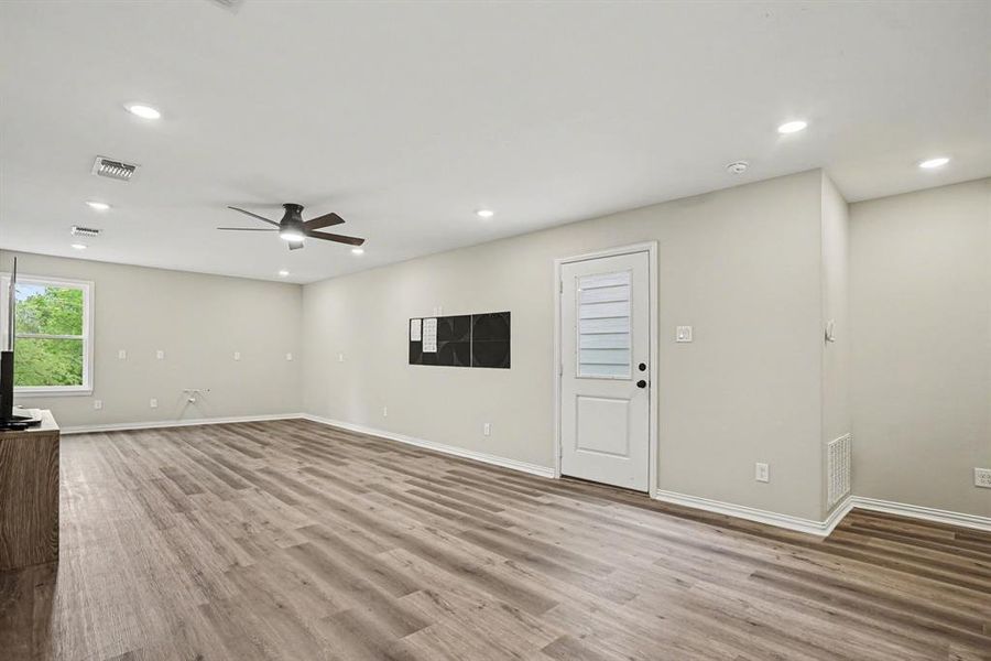 2nd Floor Living, Pre Plumbed for separate kitchenette and guest quarters w a ceiling fan, light wood vinyl floors, and recessed lighting