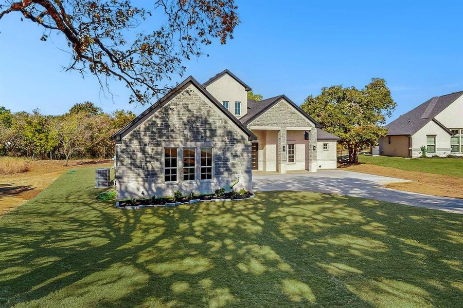 Front exterior of a new home in , Springtown, TX, highlighting curb appeal (Image 1).